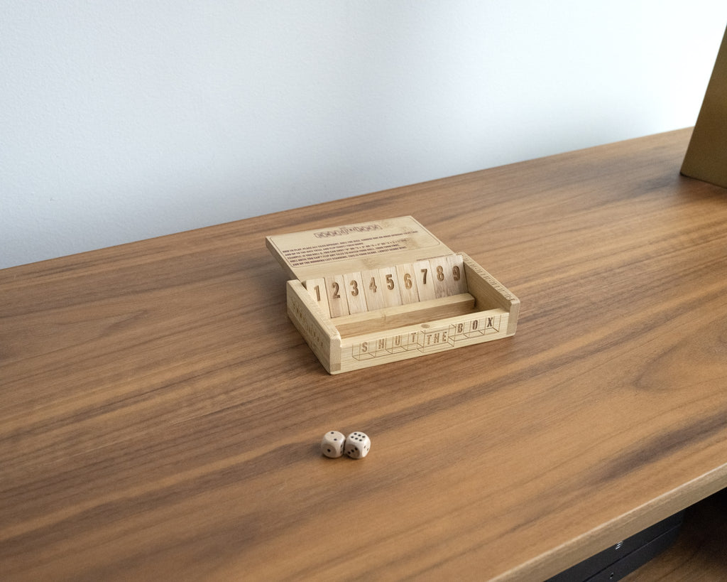 Shut the Box bamboo dice game displayed on a desk