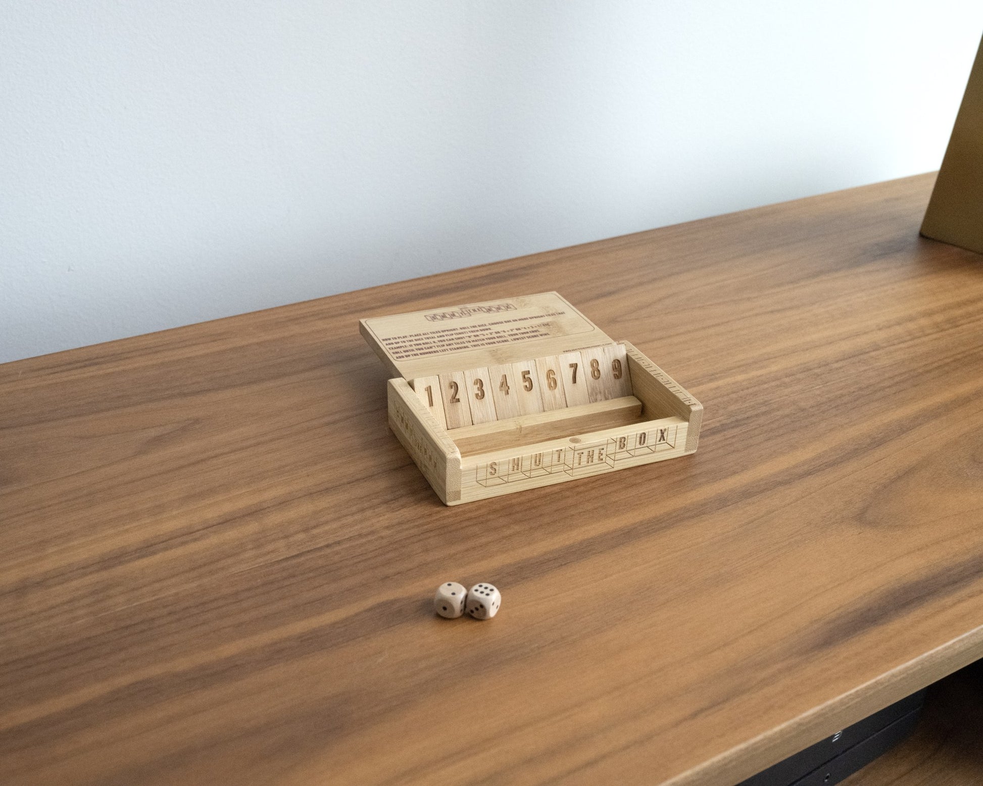 Shut the Box bamboo dice game displayed on a desk
